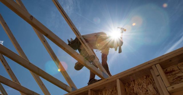 Construction worker building roof