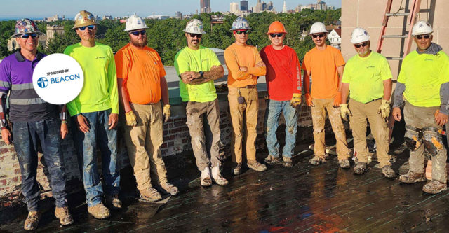 Group of roofers smiling, posing for photo